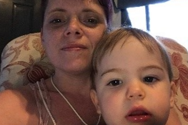 Mom and baby sitting in a chair - taking a selfie