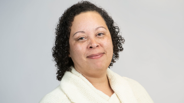 Zalika Winitzer, Senior Director of Talent, Equity, and Belonging at Community Catalyst, smiles directly at the camera wearing a light top in front of a light background.