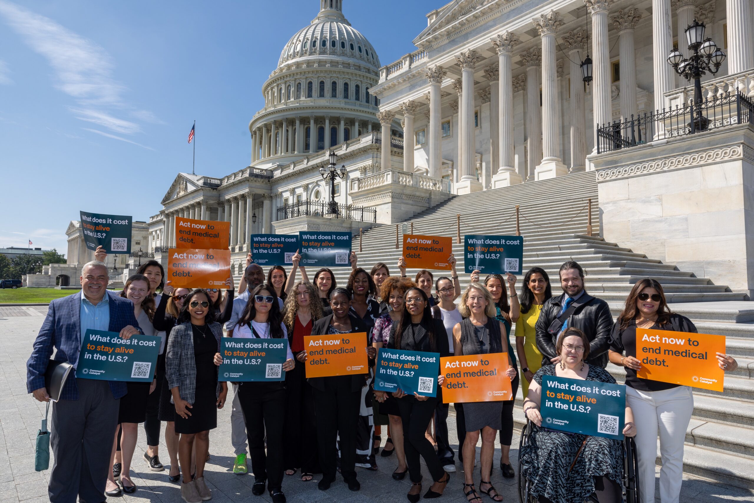 Group of community members , advocates, and Day of Action participants stand in front of steps of Capitol Hill and hold signs calling for action to end medical debt