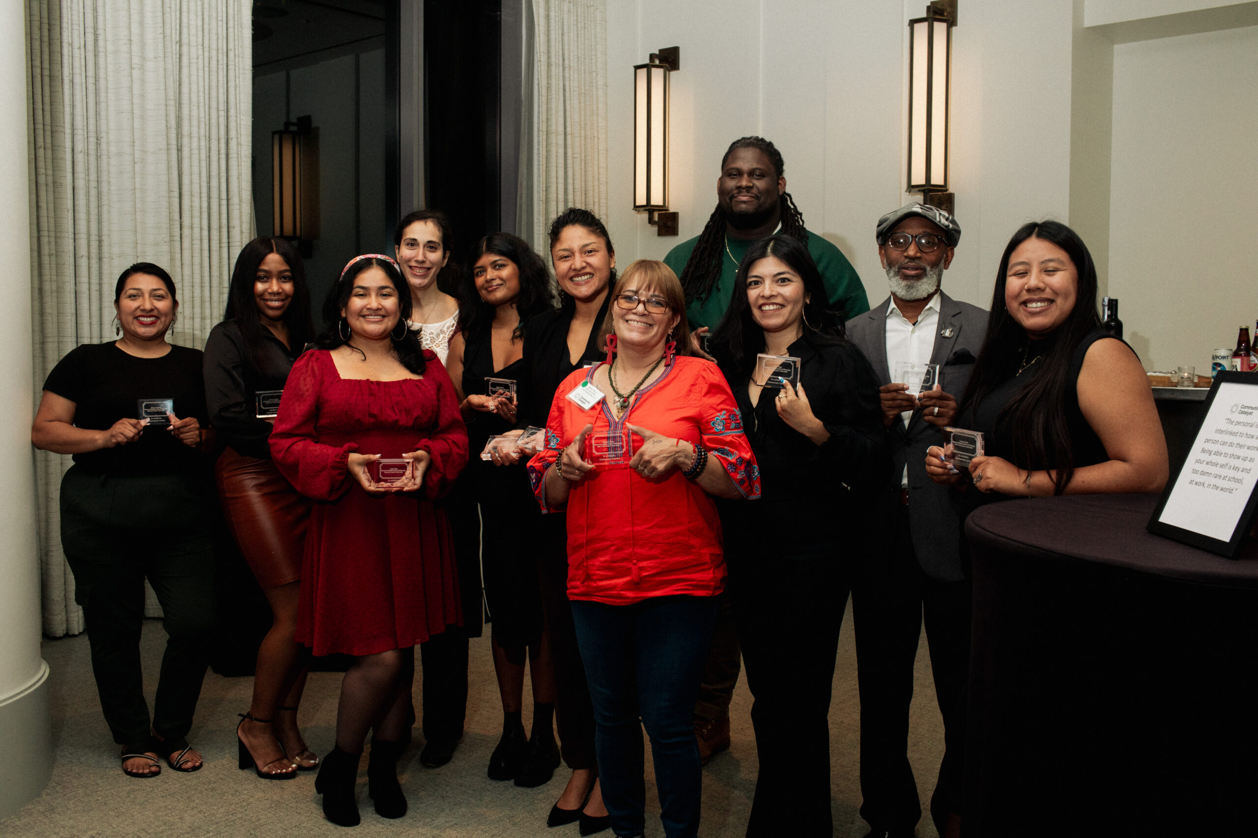Group of eleven Restuccia Health Justice fellows poses with their awards