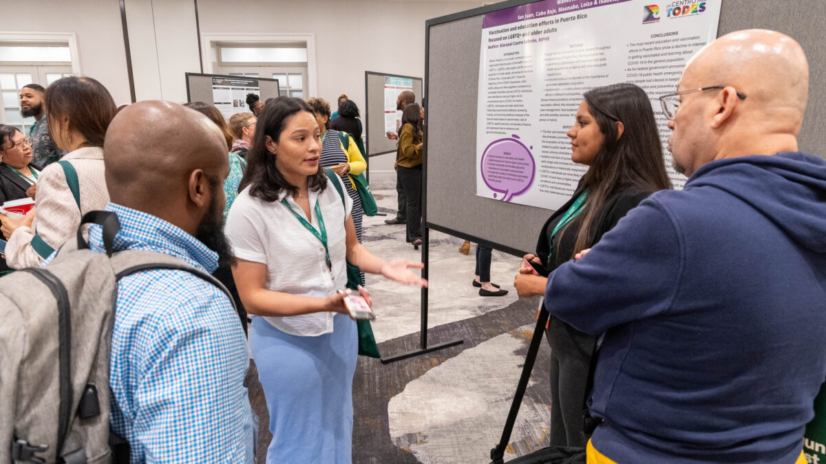 A group of community public health advocates share information during a poster session at the 2023 Vaccine Equity and Access Program