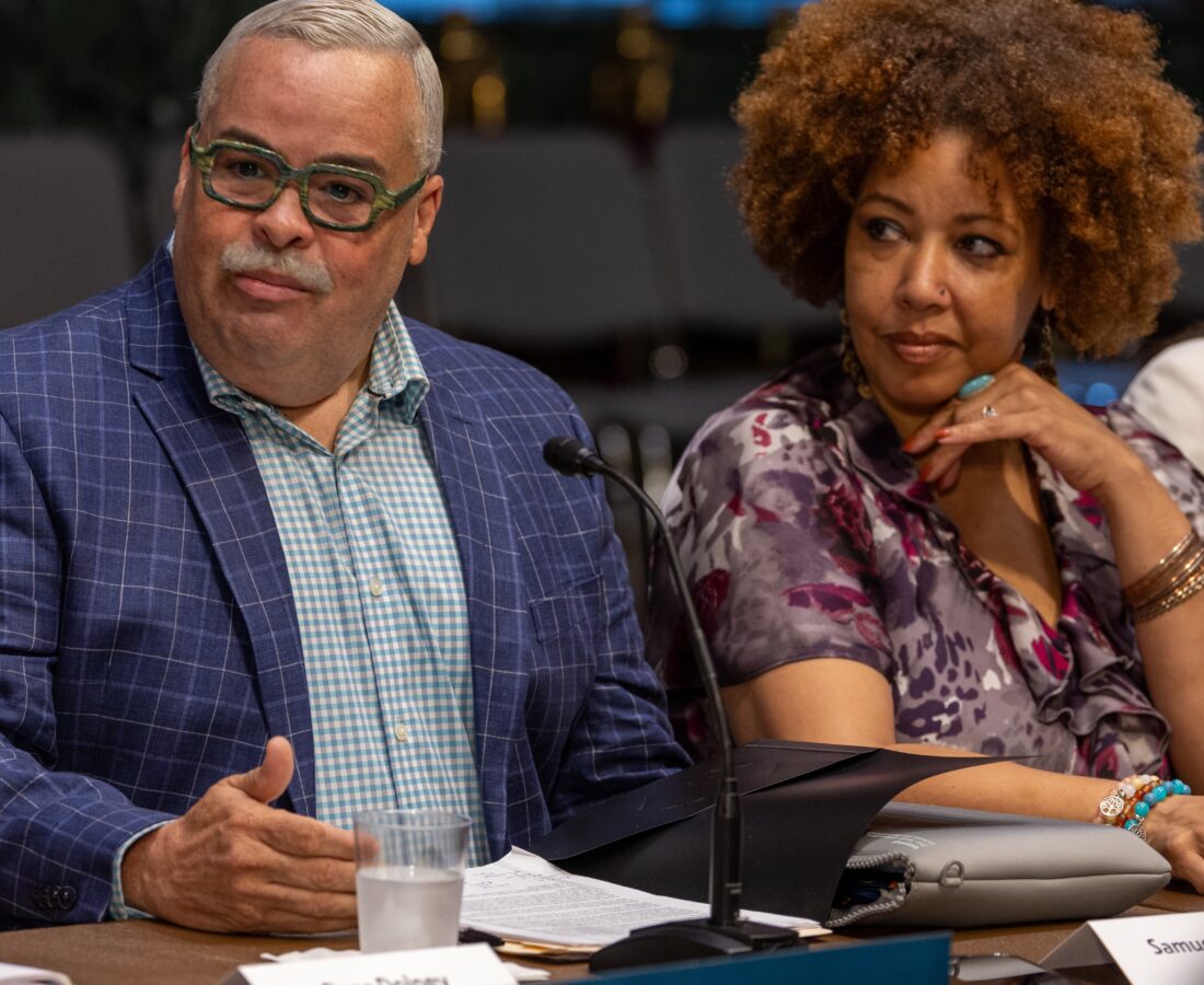 Two community members sit at a table in Washington, D.C.