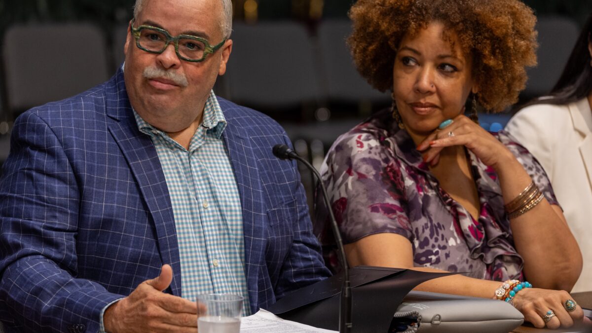 Two community members sit at a table in Washington, D.C.