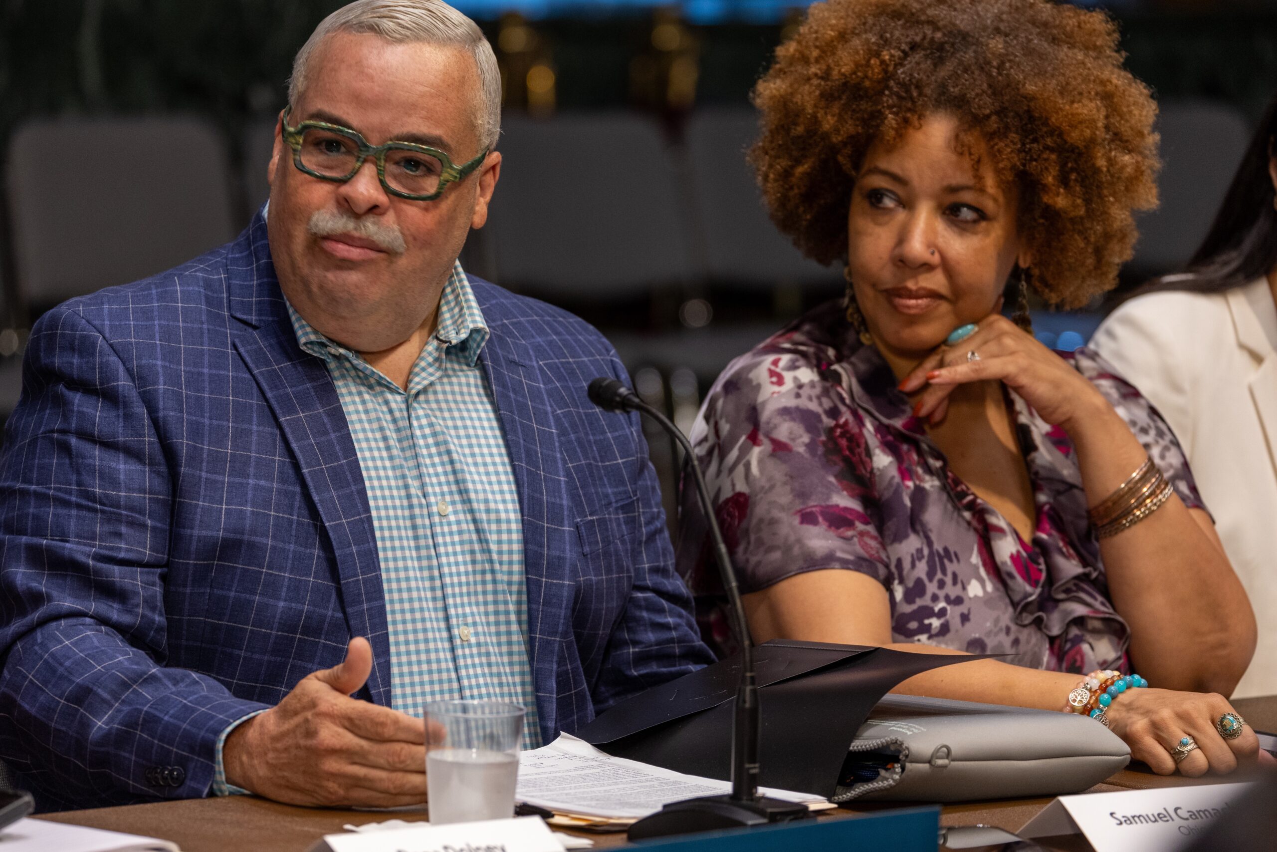 Two community members sit at a table in Washington, D.C.