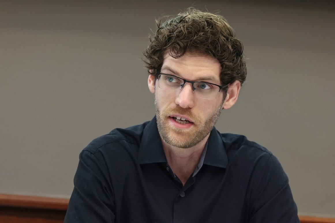 A person in a black shirt and glasses