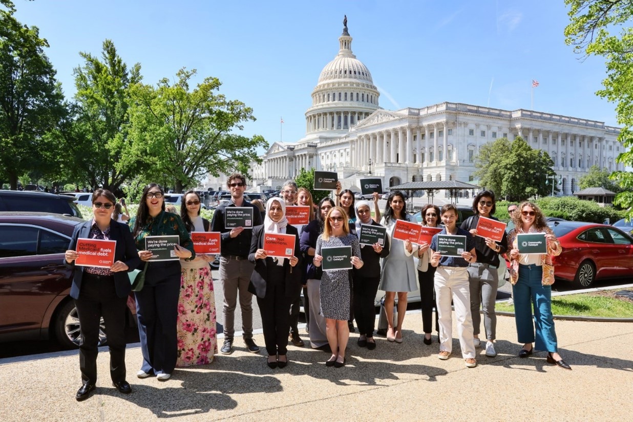 A group of people holding signs in front of the U.S. Capitol building.