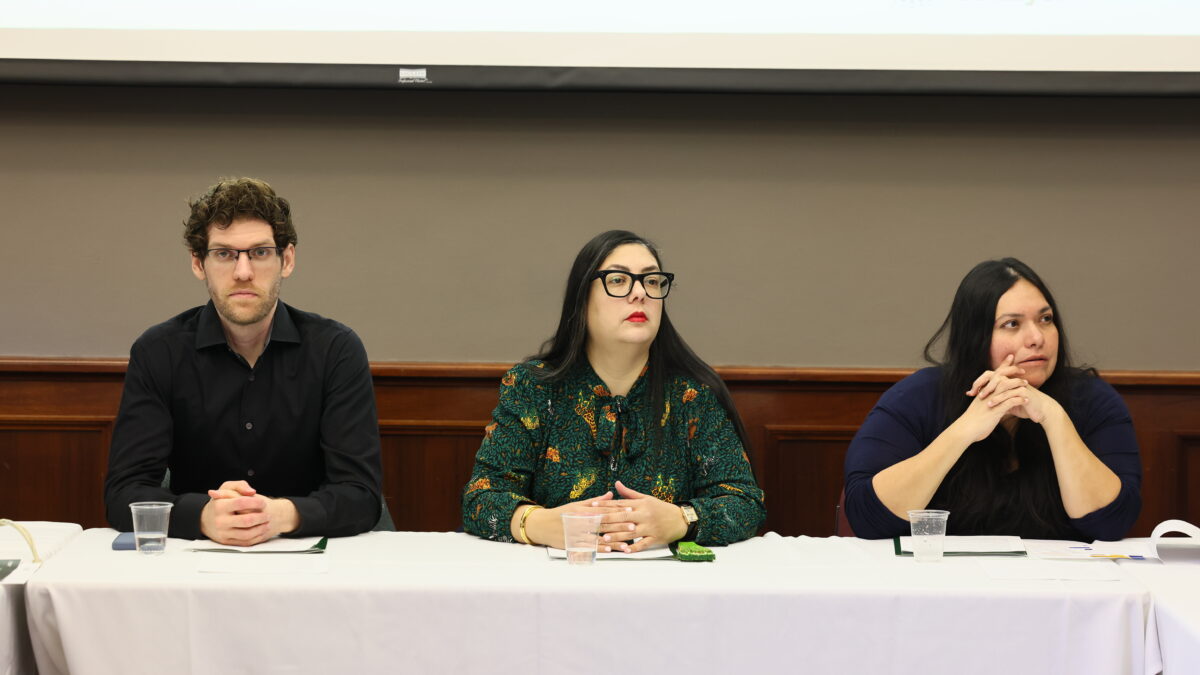 Three people sit at a roundtable in Washington, D.C.