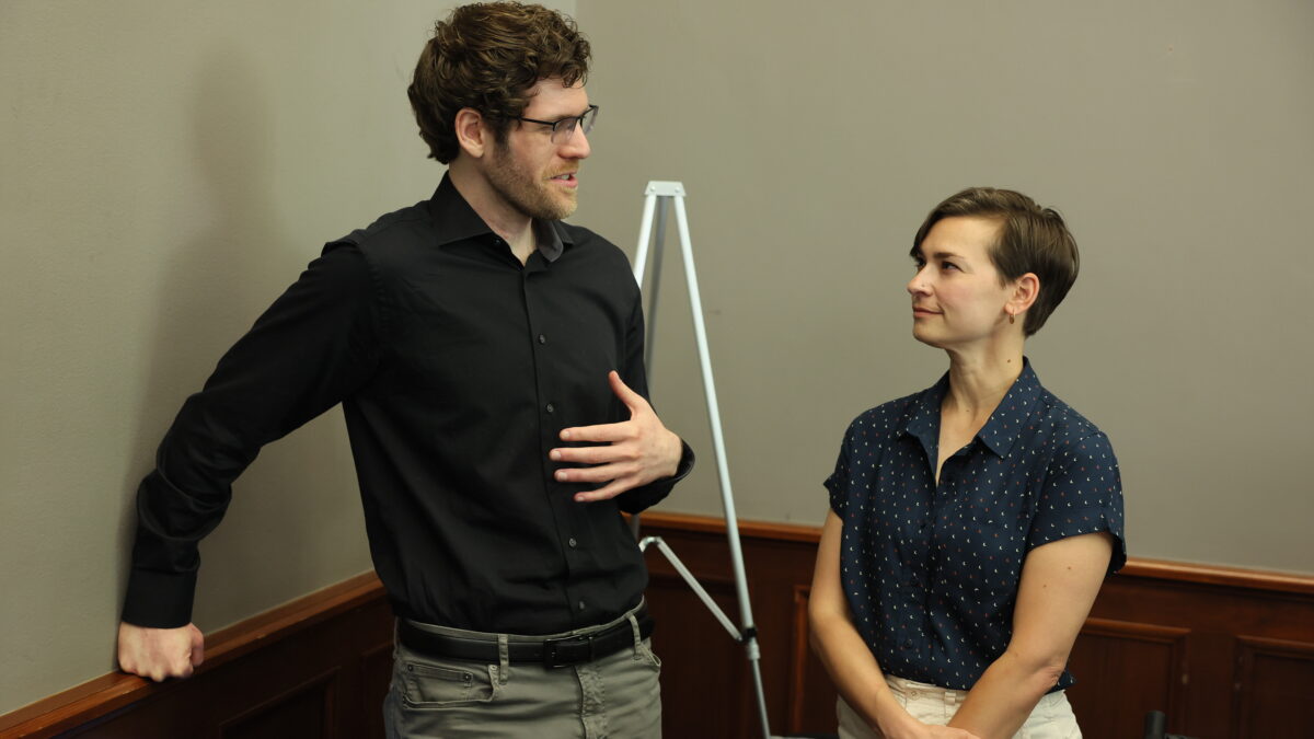 Two people speak to each other