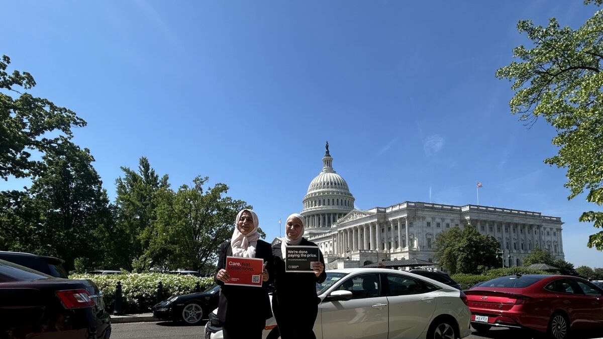 Two people pose in front of the Capitol with signs that read "Care Not collections" and "We're done paying the price."